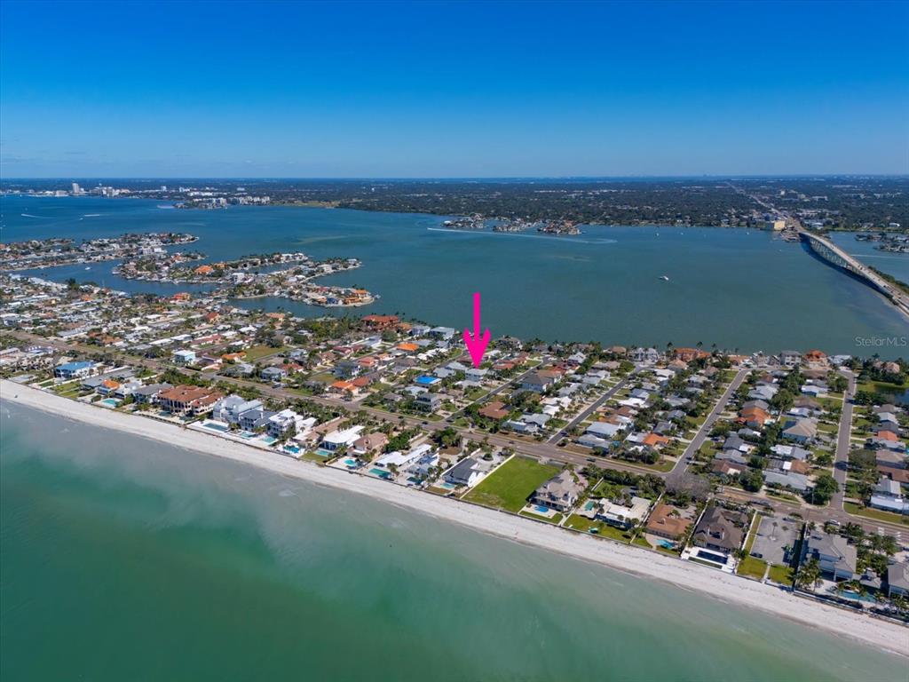 an aerial view of a residential houses with city view