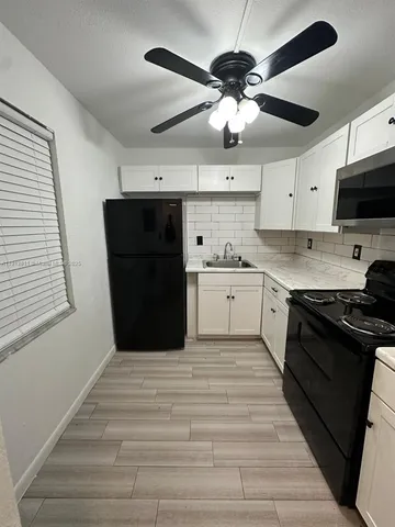 a kitchen with a stove and a sink