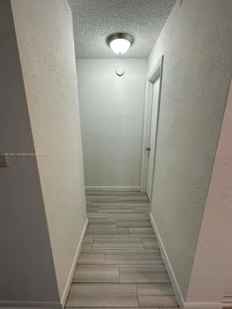 a view of hallway with stairs and wooden floor