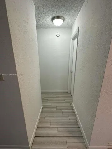 a view of hallway with stairs and wooden floor