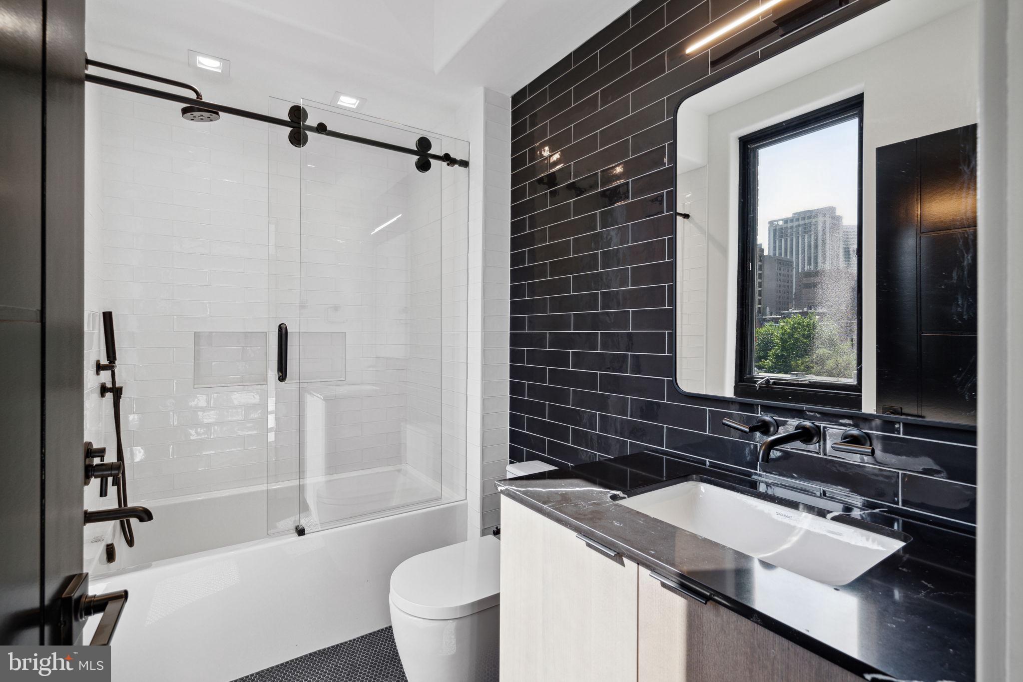 110 South Bonsall Street Philadelphia, PA 19103 - Photo 15 of 25 a bathroom with a sink toilet double vanity and shower