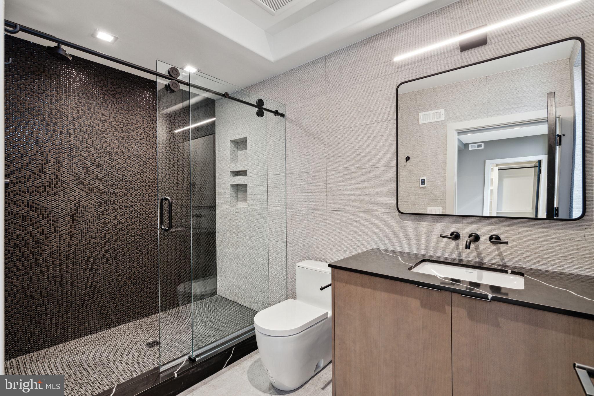 110 South Bonsall Street Philadelphia, PA 19103 - Photo 16 of 25 a bathroom with a sink a toilet and shower
