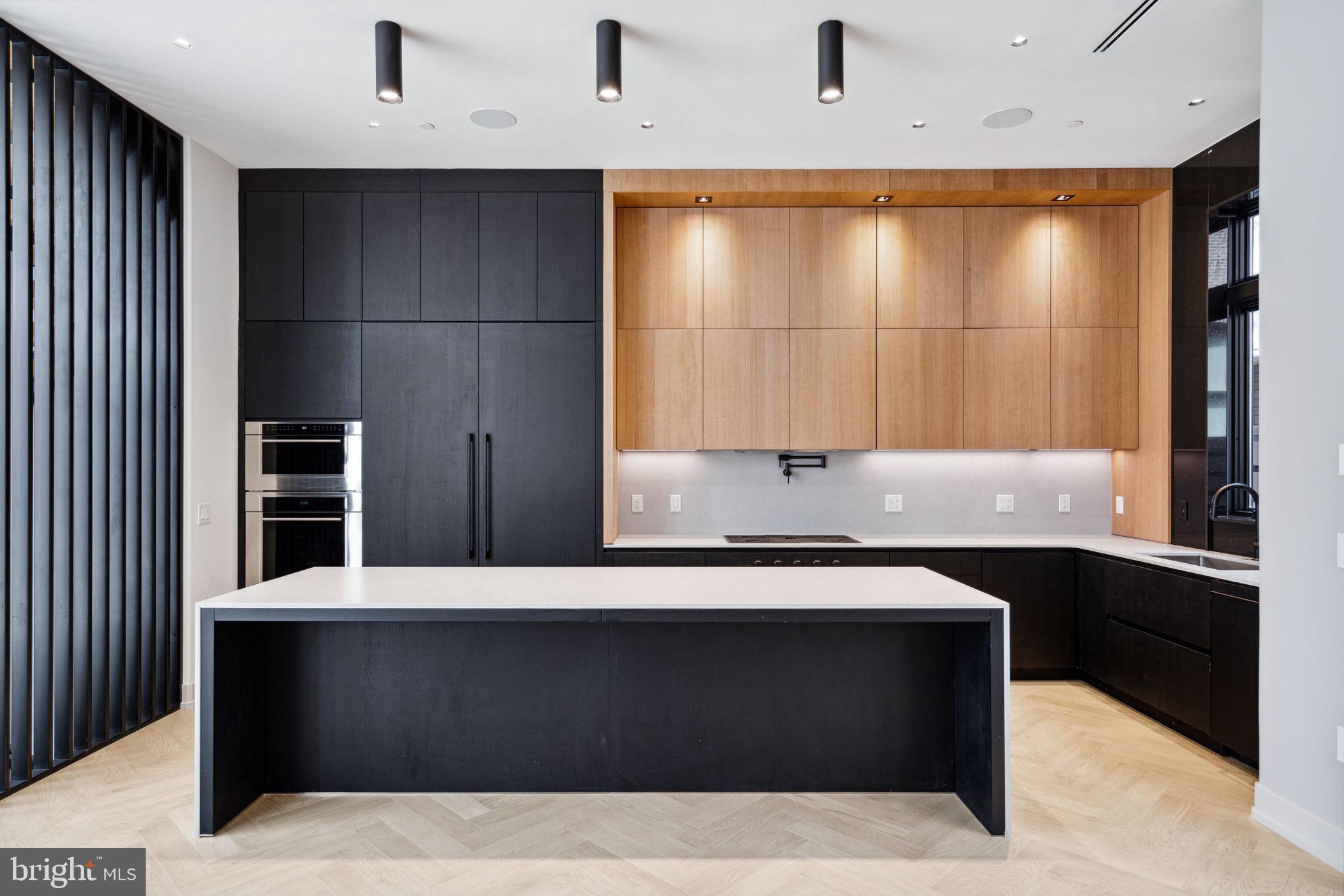 110 South Bonsall Street Philadelphia, PA 19103 - Photo 2 of 25 a black and white kitchen with a sink