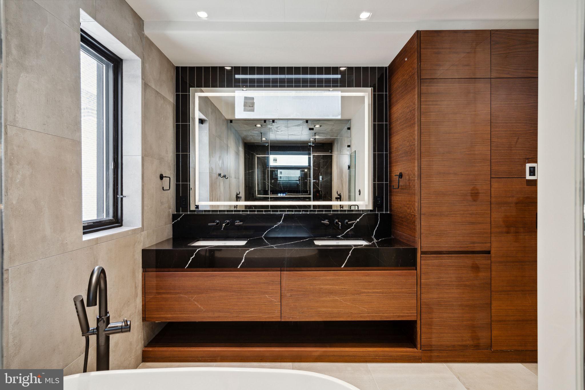 110 South Bonsall Street Philadelphia, PA 19103 - Photo 21 of 25 a bathroom with a sink and a mirror