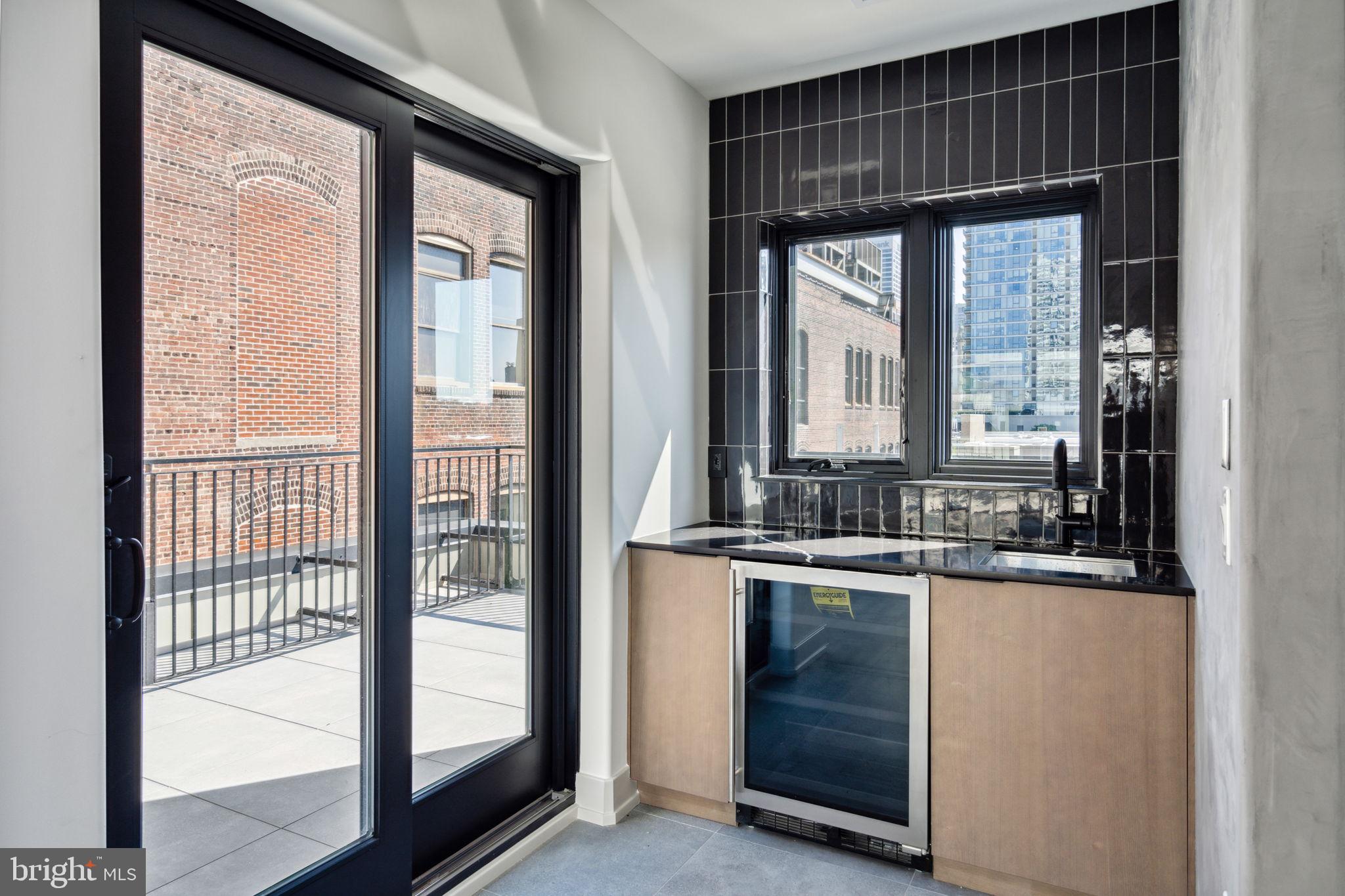 110 South Bonsall Street Philadelphia, PA 19103 - Photo 24 of 25 a kitchen with a sink and large window