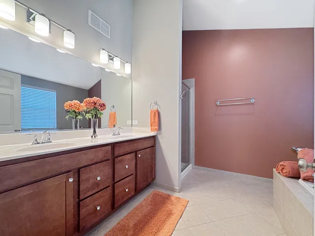 a spacious bathroom with a double vanity sink and a mirror