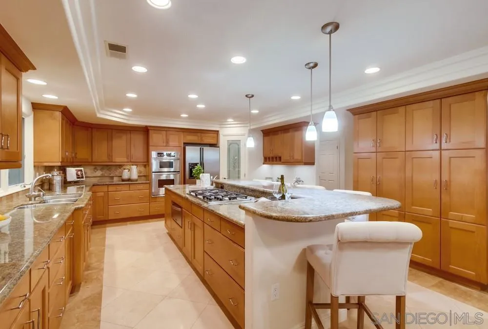 16052 Country Day Road Poway, CA 92064 - Photo 30 of 75 a large kitchen with kitchen island a large island in it