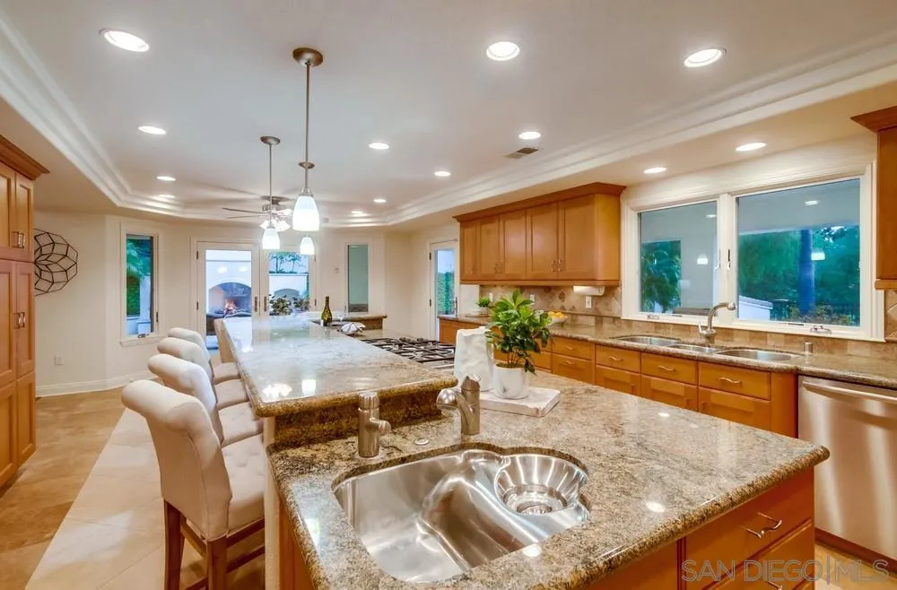 16052 Country Day Road Poway, CA 92064 - Photo 33 of 75 a view of a dining room and livingroom with furniture wooden floor a chandelier