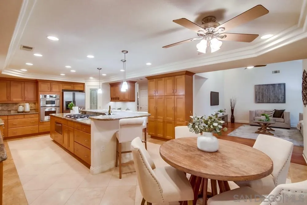 16052 Country Day Road Poway, CA 92064 - Photo 34 of 75 a large kitchen with a table and chairs