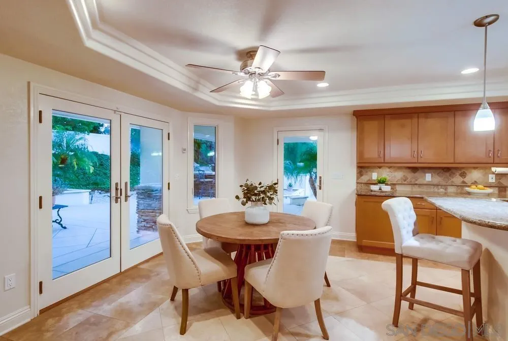 16052 Country Day Road Poway, CA 92064 - Photo 35 of 75 a view of a dining room with furniture and a chandelier fan