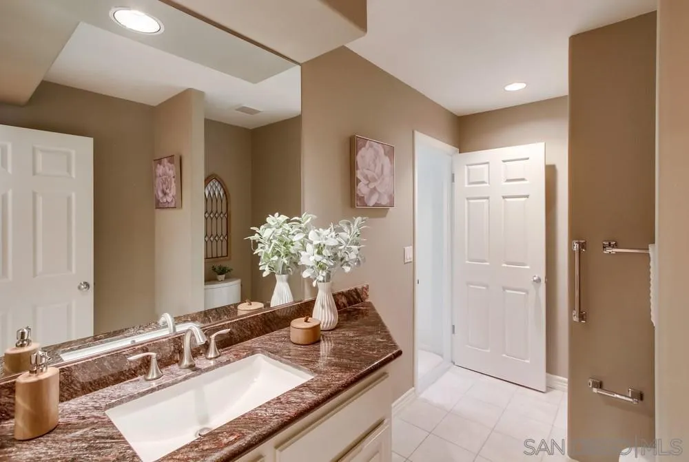 16052 Country Day Road Poway, CA 92064 - Photo 41 of 75 a bathroom with a granite countertop sink and a mirror