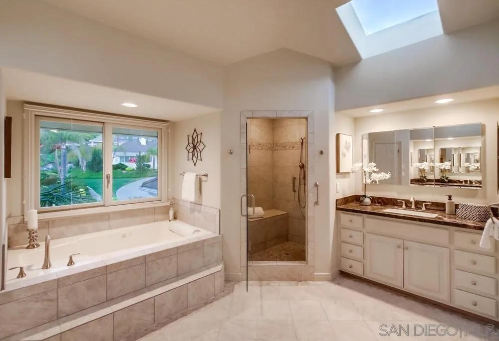 16052 Country Day Road Poway, CA 92064 - Photo 48 of 75 a spacious bathroom with a tub sink and mirror