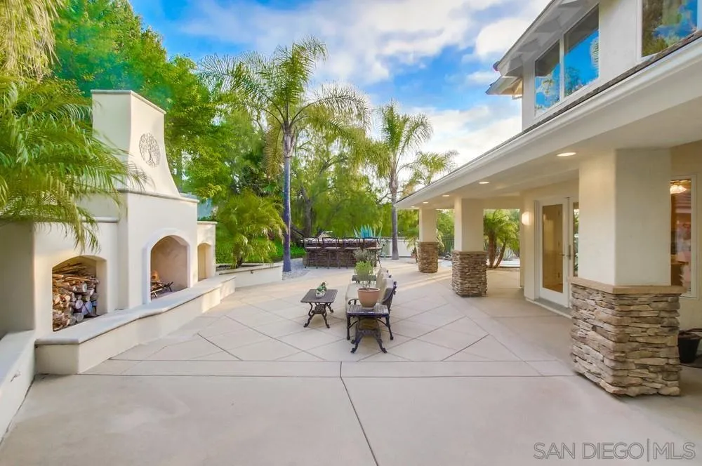 16052 Country Day Road Poway, CA 92064 - Photo 57 of 75 a view of a patio with couches table and chairs and potted plants
