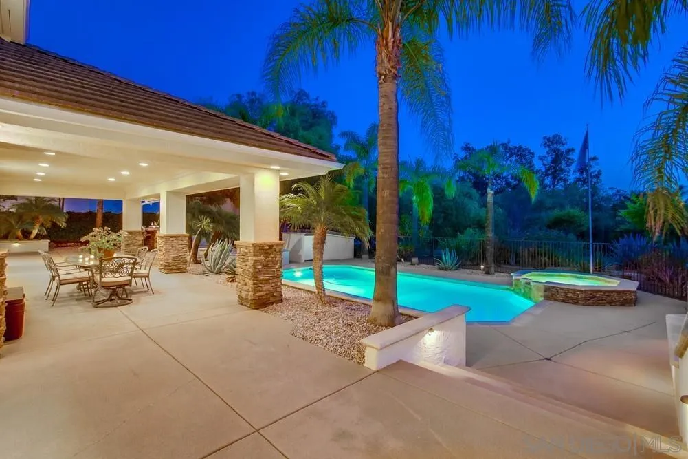 16052 Country Day Road Poway, CA 92064 - Photo 8 of 75 a view of a patio with table and chairs potted plants and palm trees