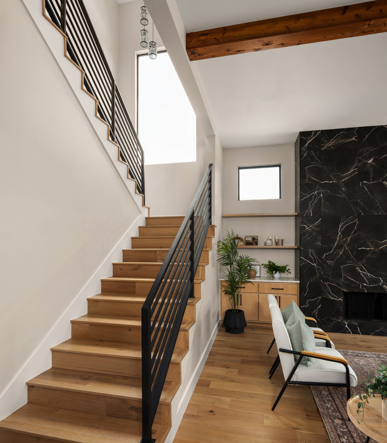 1909 West 40th Street Austin, TX 78731 - Photo 26 of 40 The modern staircase design serves as an architectural focal point, seamlessly connecting the home’s thoughtfully designed living spaces.