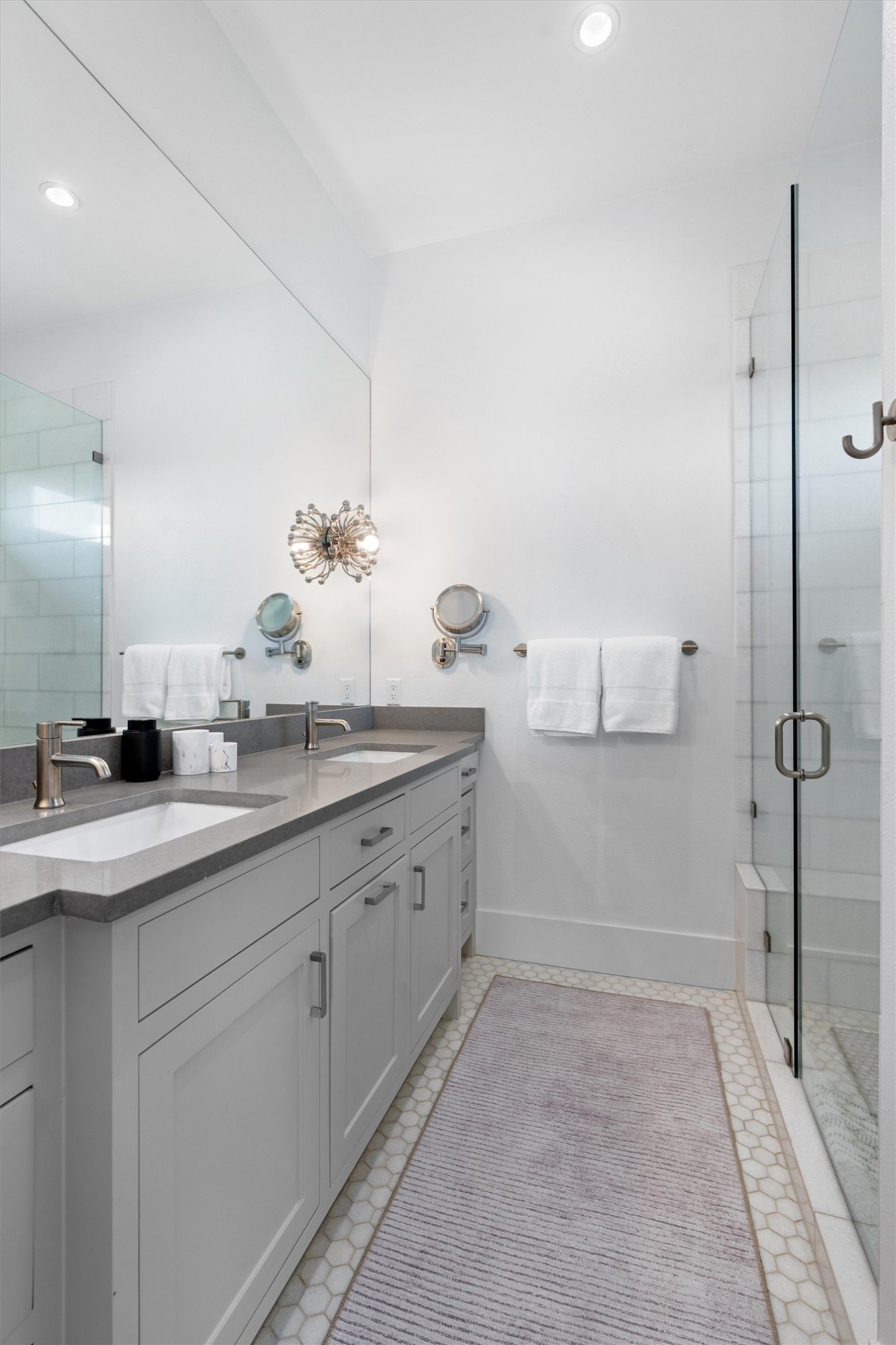 1500 The High Road Austin, TX 78746 - Photo 30 of 40 En-Suite Bathroom featuring a double vanity with grey cabinetry and light-toned countertops, a full-width wall mirror, recessed lighting, and a glass-enclosed shower with a built-in bench