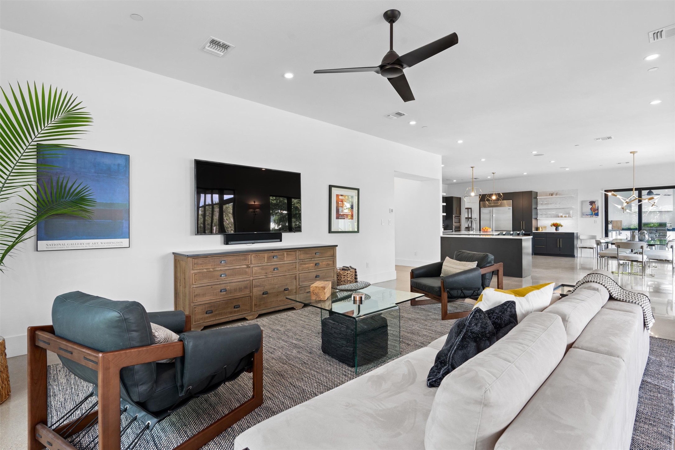 1500 The High Road Austin, TX 78746 - Photo 5 of 40 Spacious open-concept living area featuring high ceilings with recessed lighting, a modern ceiling fan, and concrete flooring