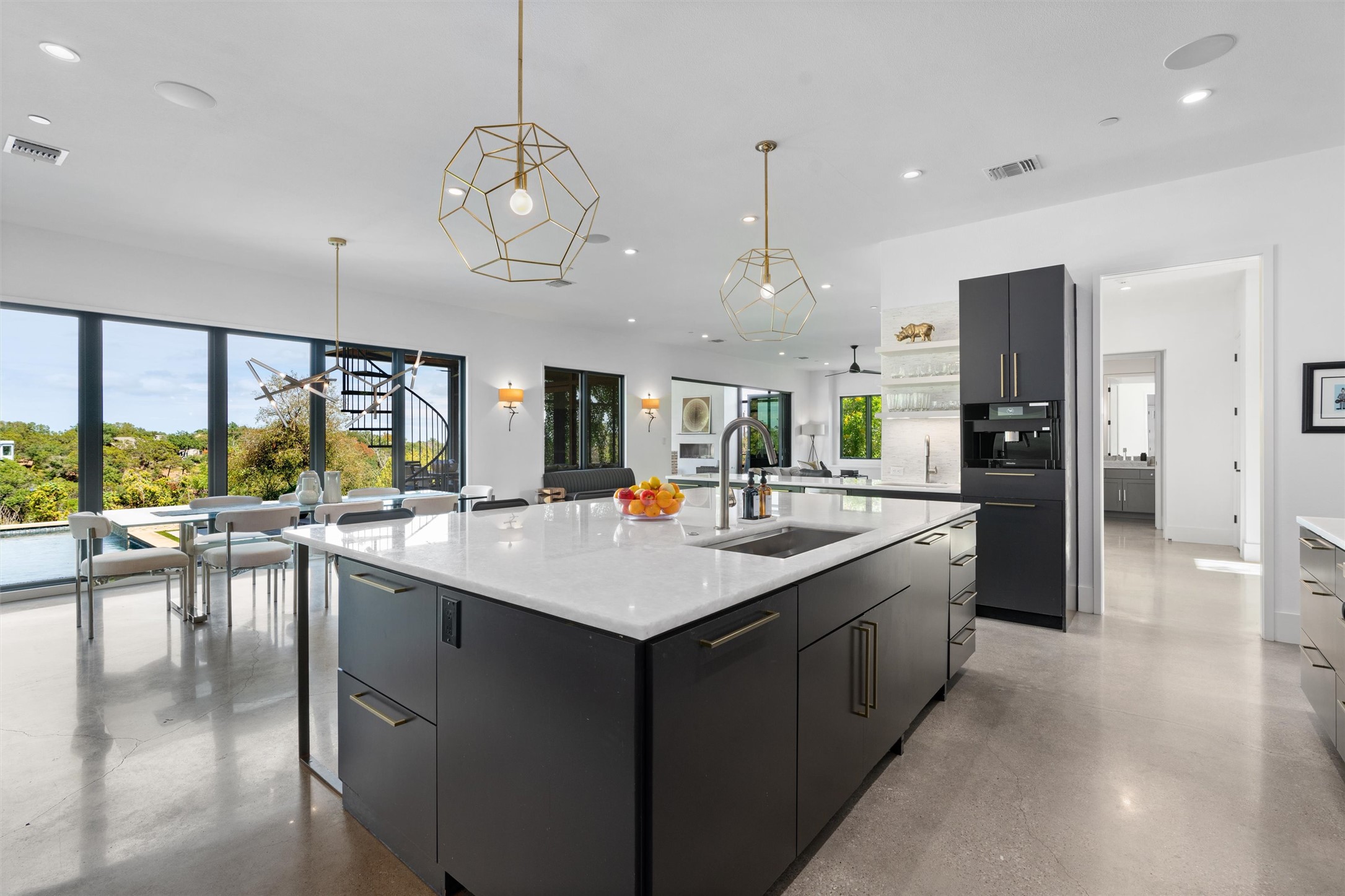 1500 The High Road Austin, TX 78746 - Photo 9 of 40 Kitchen featuring a large central island with a sink, grey cabinetry, and white countertops