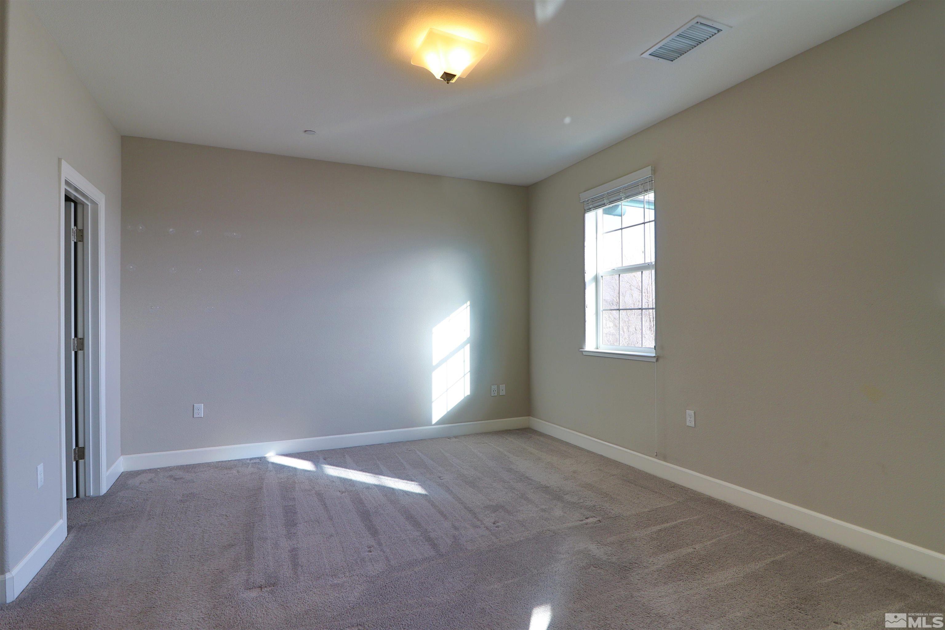 1920 Dark Horse Road, Unit C Reno, NV 89521 - Photo 11 of 26 an empty room with windows and closet