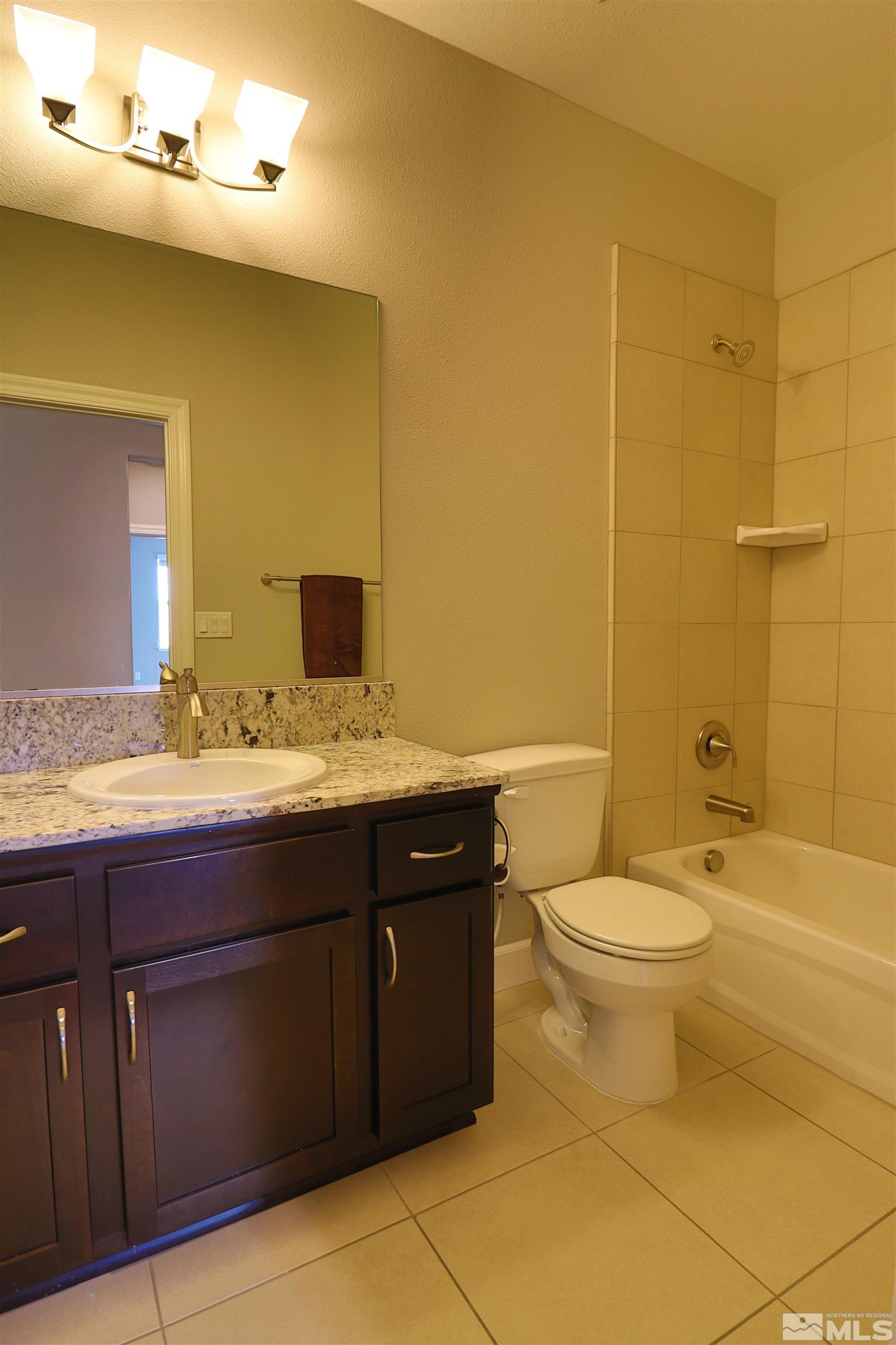 1920 Dark Horse Road, Unit C Reno, NV 89521 - Photo 17 of 26 a bathroom with a sink a toilet and shower