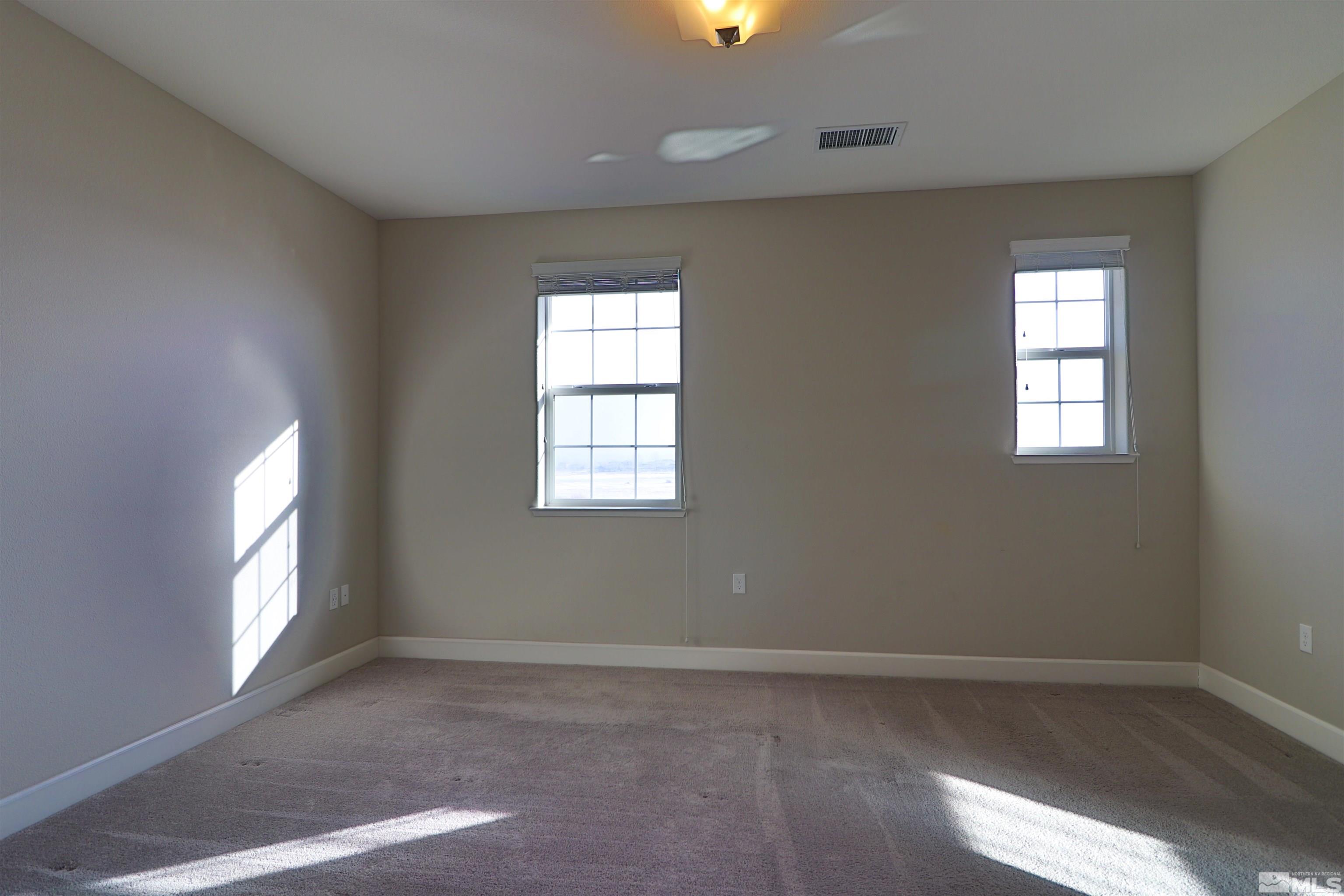 1920 Dark Horse Road, Unit C Reno, NV 89521 - Photo 10 of 26 an empty room with wooden floor and windows