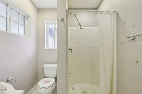 a white toilet sitting next to a bathroom sink