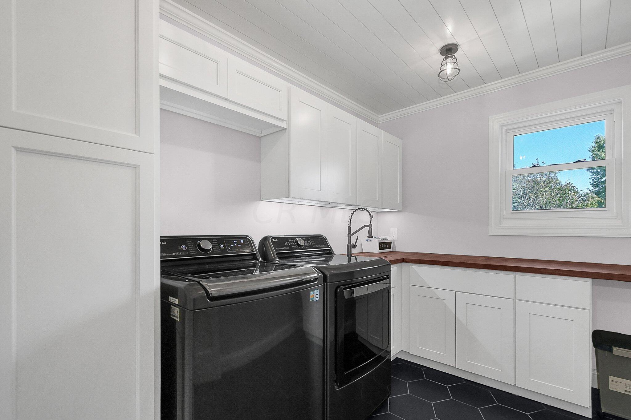3620 Hyatts Road Powell, OH 43065 - Photo 11 of 54 New dream 1st floor laundry with black octagon tile, under counter lighting, butcher block counter and ship lap ceiling!