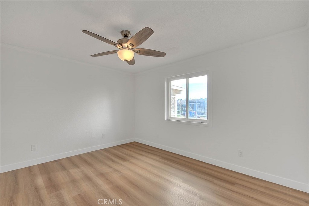 22133 Thunderbird Road Apple Valley, CA 92307 - Photo 15 of 29 an empty room with a window and a fan