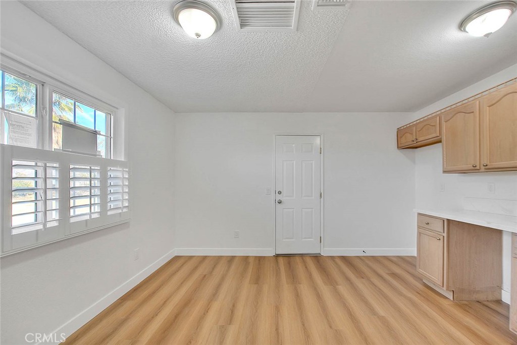 22133 Thunderbird Road Apple Valley, CA 92307 - Photo 7 of 29 wooden floor in an empty room with a window