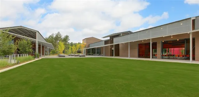 a view of a lake with a yard and trees