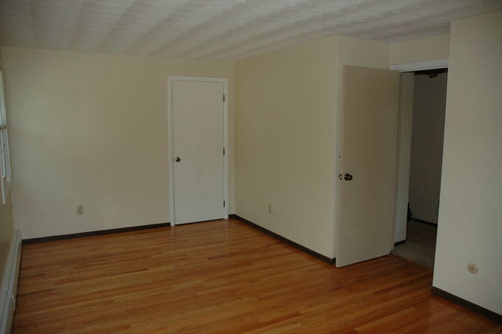 13 Ansie Road Chelmsford, MA 01824 - Photo 17 of 30 a view of an empty room with wooden floor and closet