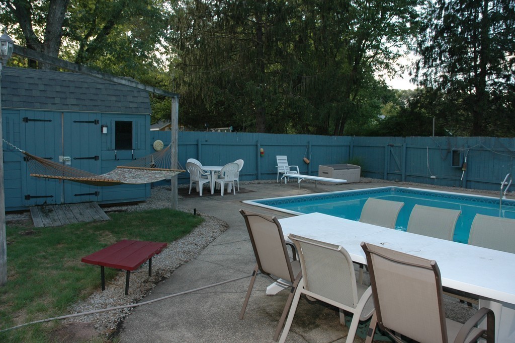 13 Ansie Road Chelmsford, MA 01824 - Photo 26 of 30 a view of a backyard with table and chairs potted plants and a large tree