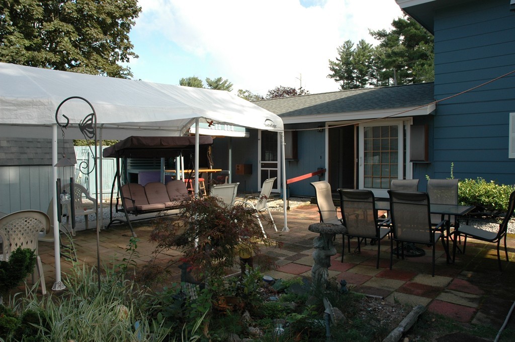 13 Ansie Road Chelmsford, MA 01824 - Photo 27 of 30 a view of a patio with table and chairs under an umbrella