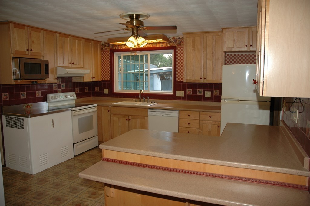 13 Ansie Road Chelmsford, MA 01824 - Photo 5 of 30 a kitchen with stainless steel appliances granite countertop a sink dishwasher a stove and a microwave oven with cabinets