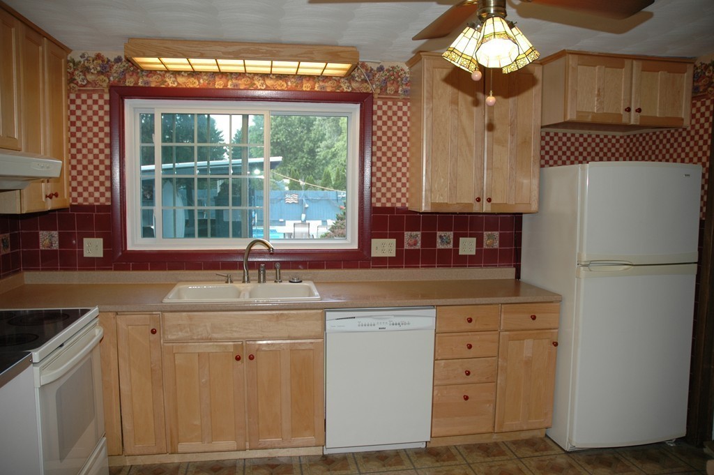 13 Ansie Road Chelmsford, MA 01824 - Photo 6 of 30 a kitchen with granite countertop a sink stainless steel appliances and cabinets