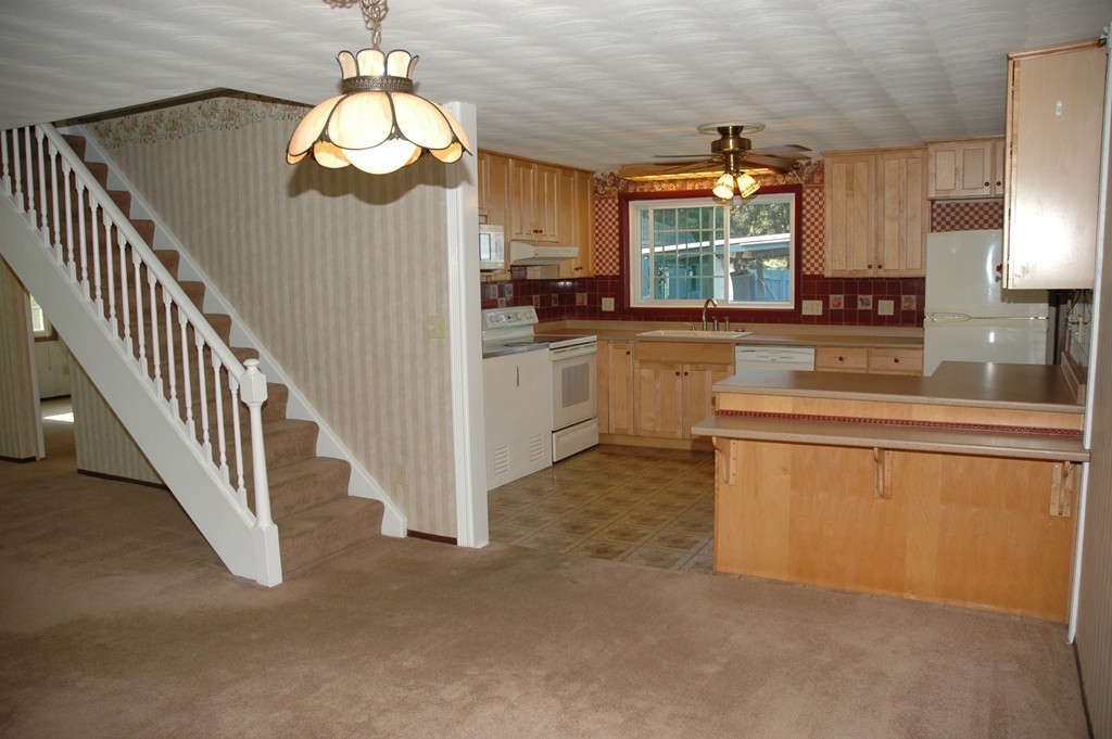 13 Ansie Road Chelmsford, MA 01824 - Photo 7 of 30 a kitchen with stainless steel appliances granite countertop a stove a sink and a refrigerator