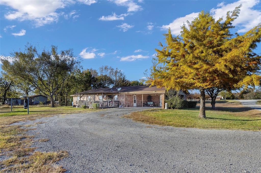 717 Houston Street Anna, TX 75409 - Photo 16 of 25 a view of big yard with a house in the background