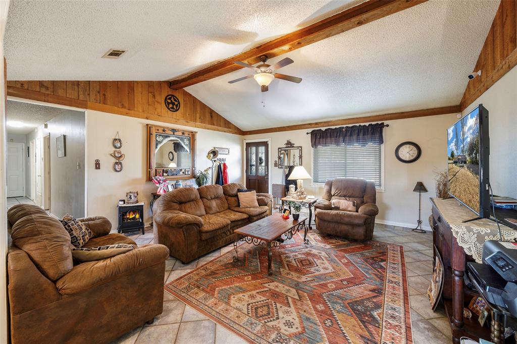 717 Houston Street Anna, TX 75409 - Photo 8 of 25 a living room with furniture and a flat screen tv