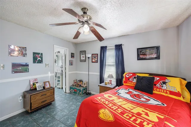 a bedroom with bed and window