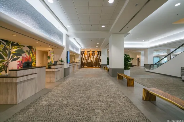 a living room with furniture and potted plant