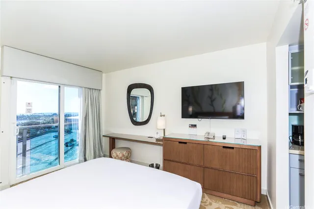 a room with a bed and a flat screen tv