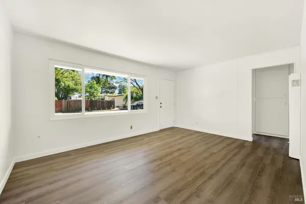 a kitchen with granite countertop white cabinets and a sink
