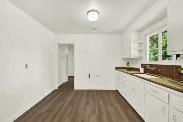 a view of a room with wooden floor