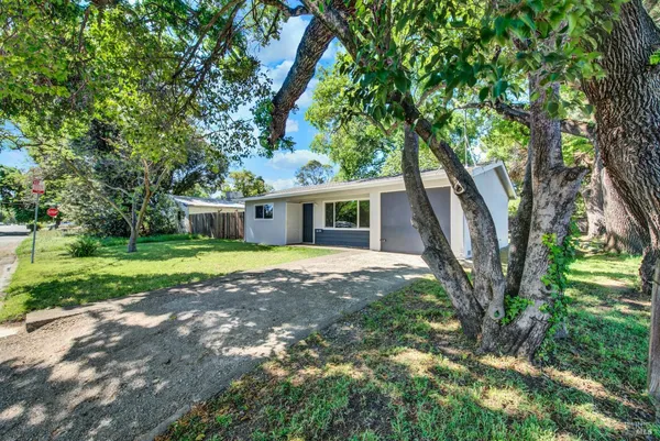 a view of a house with yard and tree s
