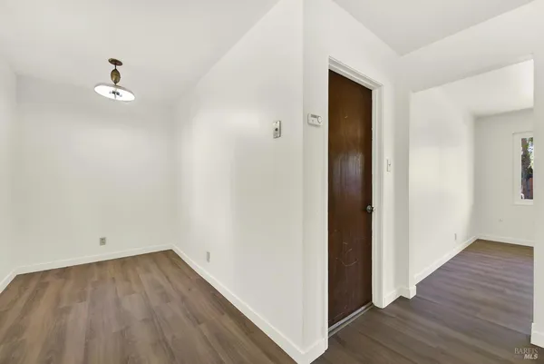 an empty room with wooden floor and a window