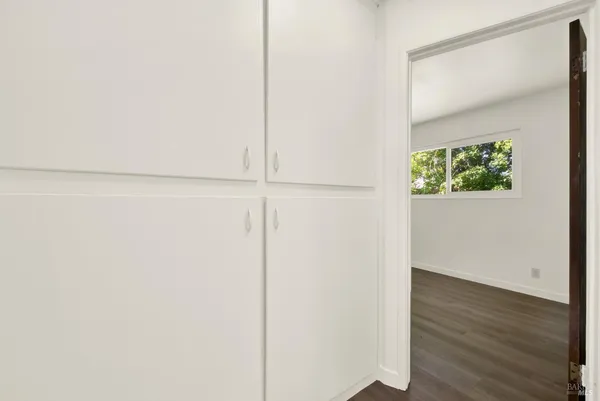 an empty room with wooden floor and closet