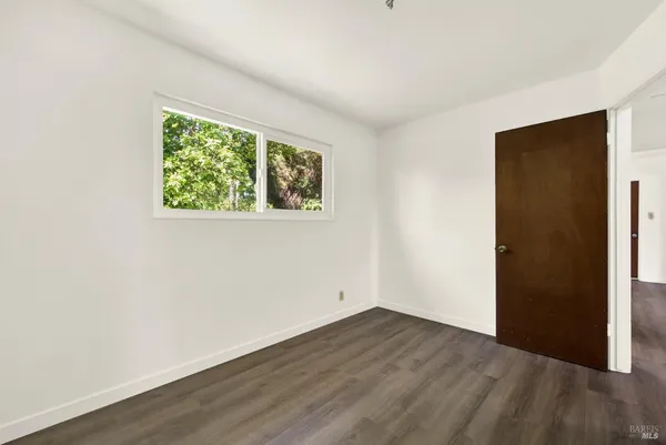 a view of a house with backyard and trees
