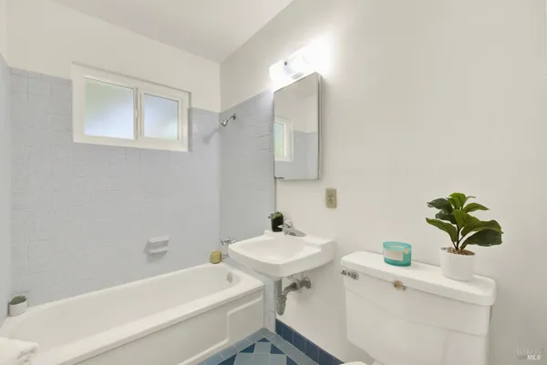 a view of a house with a yard and large trees