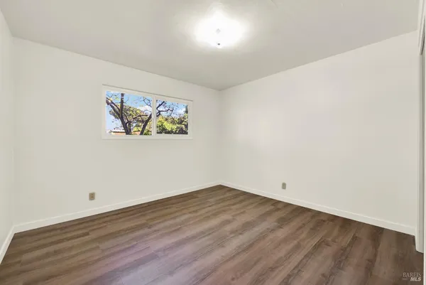 a view of backyard with barbeque grill and large trees