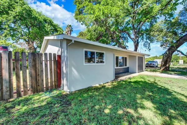 a view of backyard of house with green space